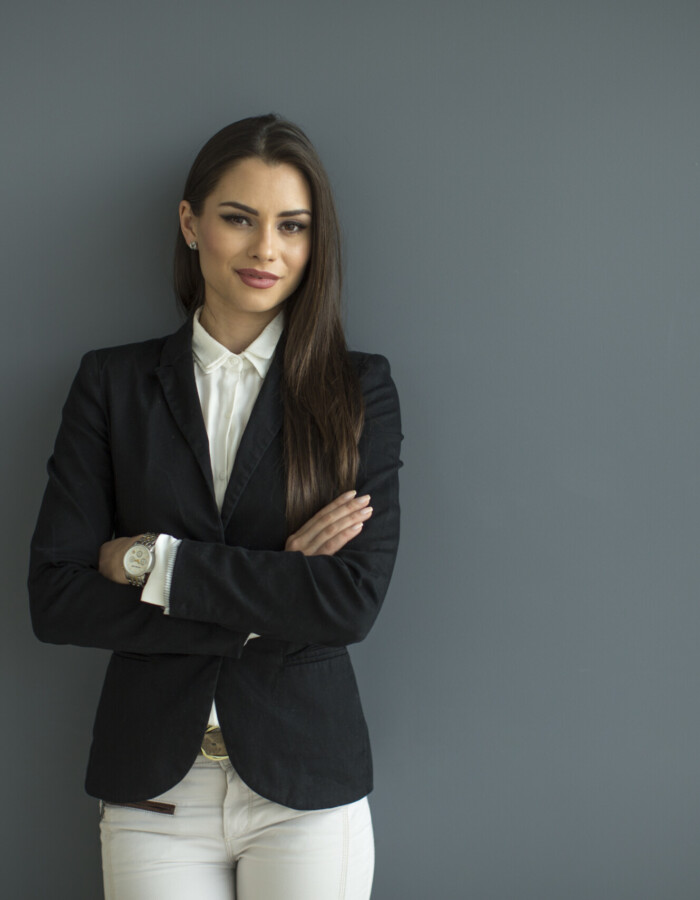 Young bussiness woman by the wall